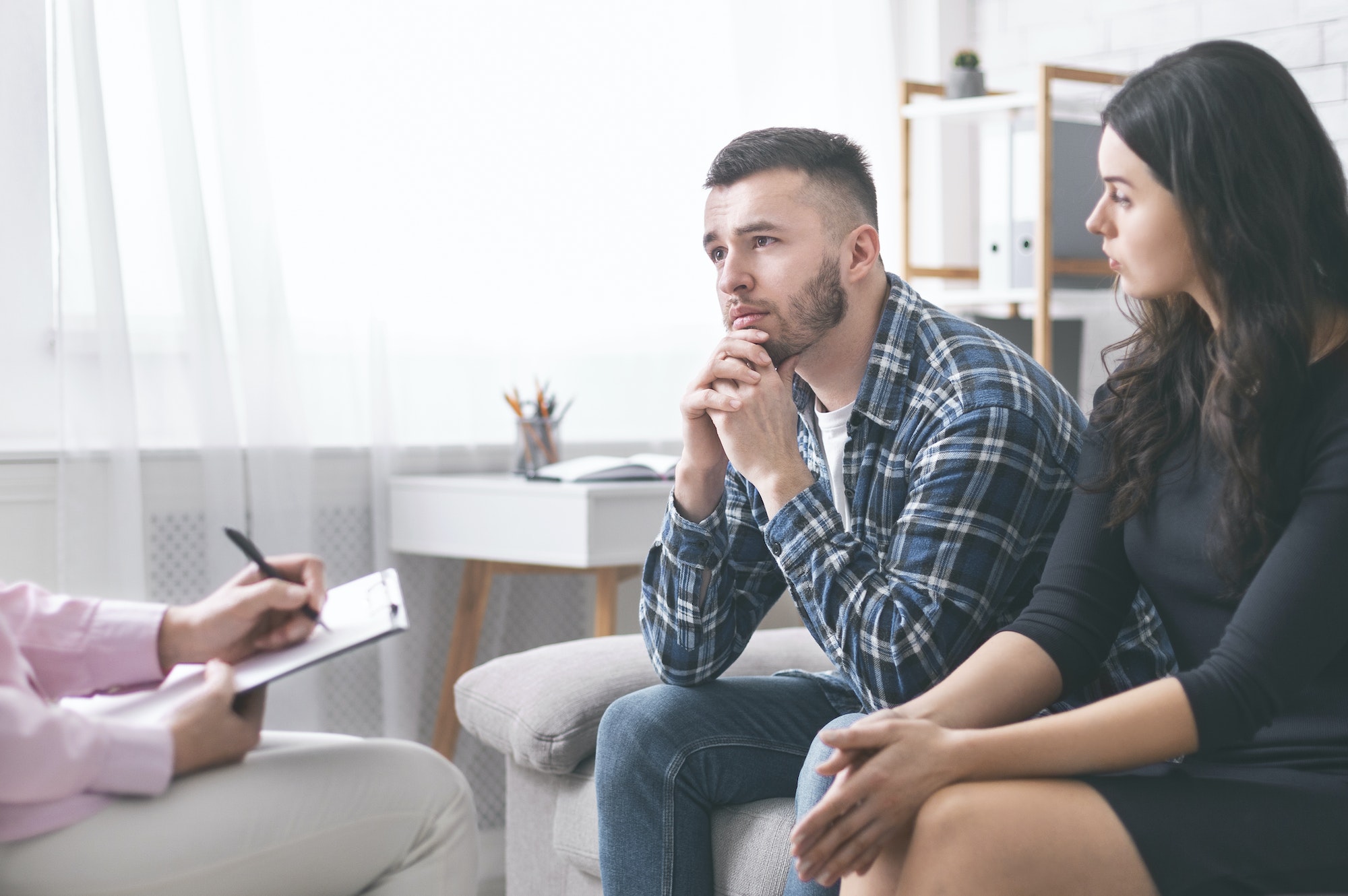 Young grumpy couple at marital counseling therapy